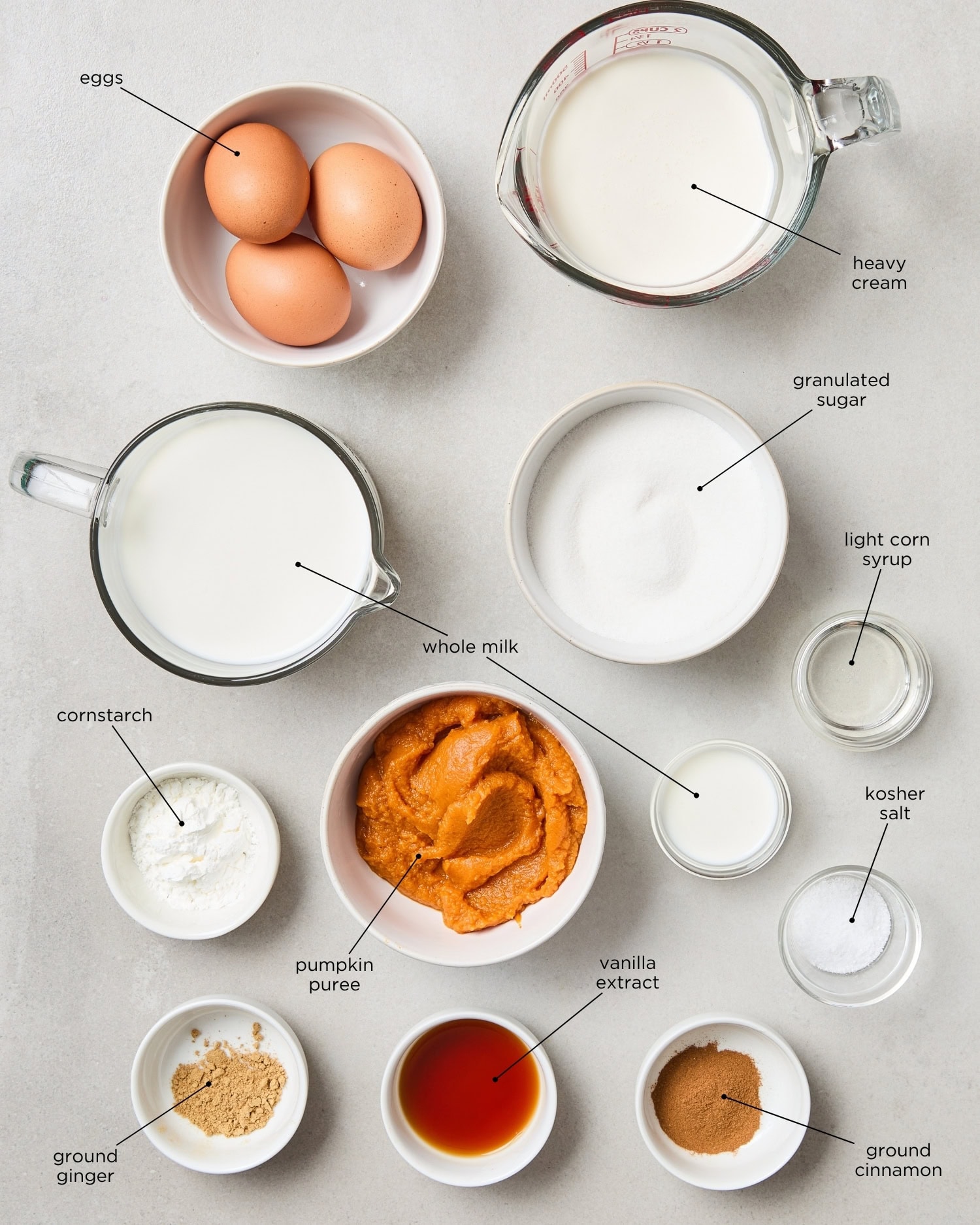 Concrete surface filled with ingredients for pumpkin ice cream.