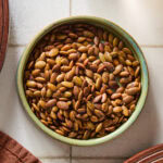A small bowl filled with roasted pepitas.