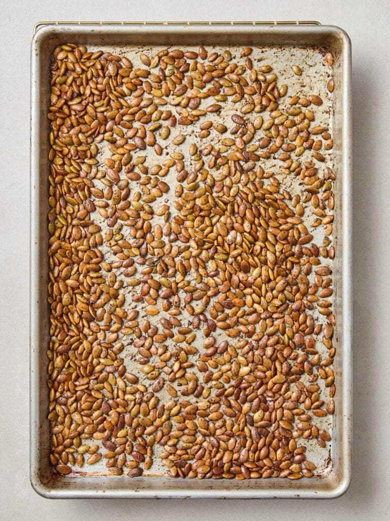 Pepitas on a baking sheet after roasting.