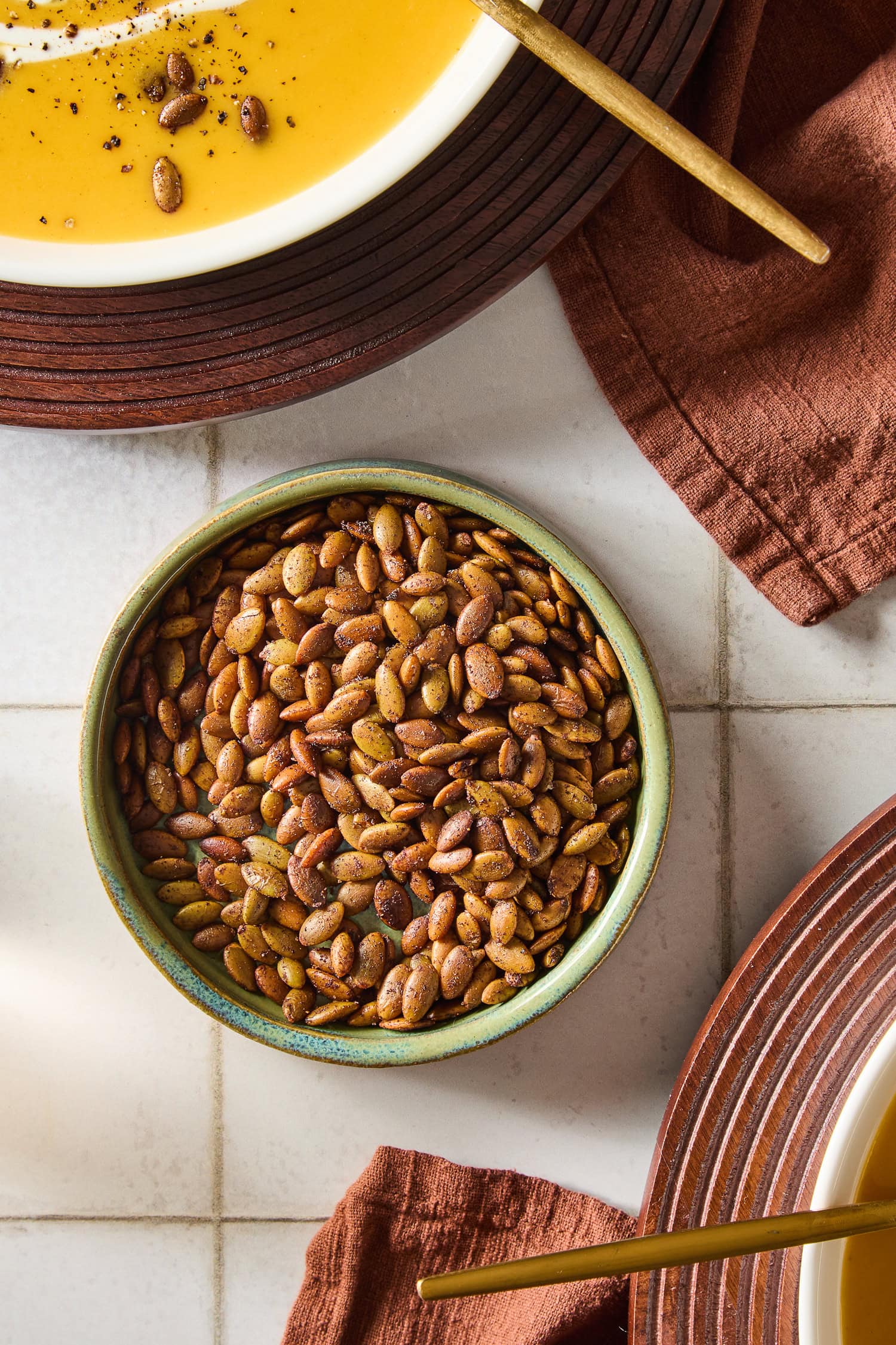 Roasted pepitas in a small bowl on a countertop.