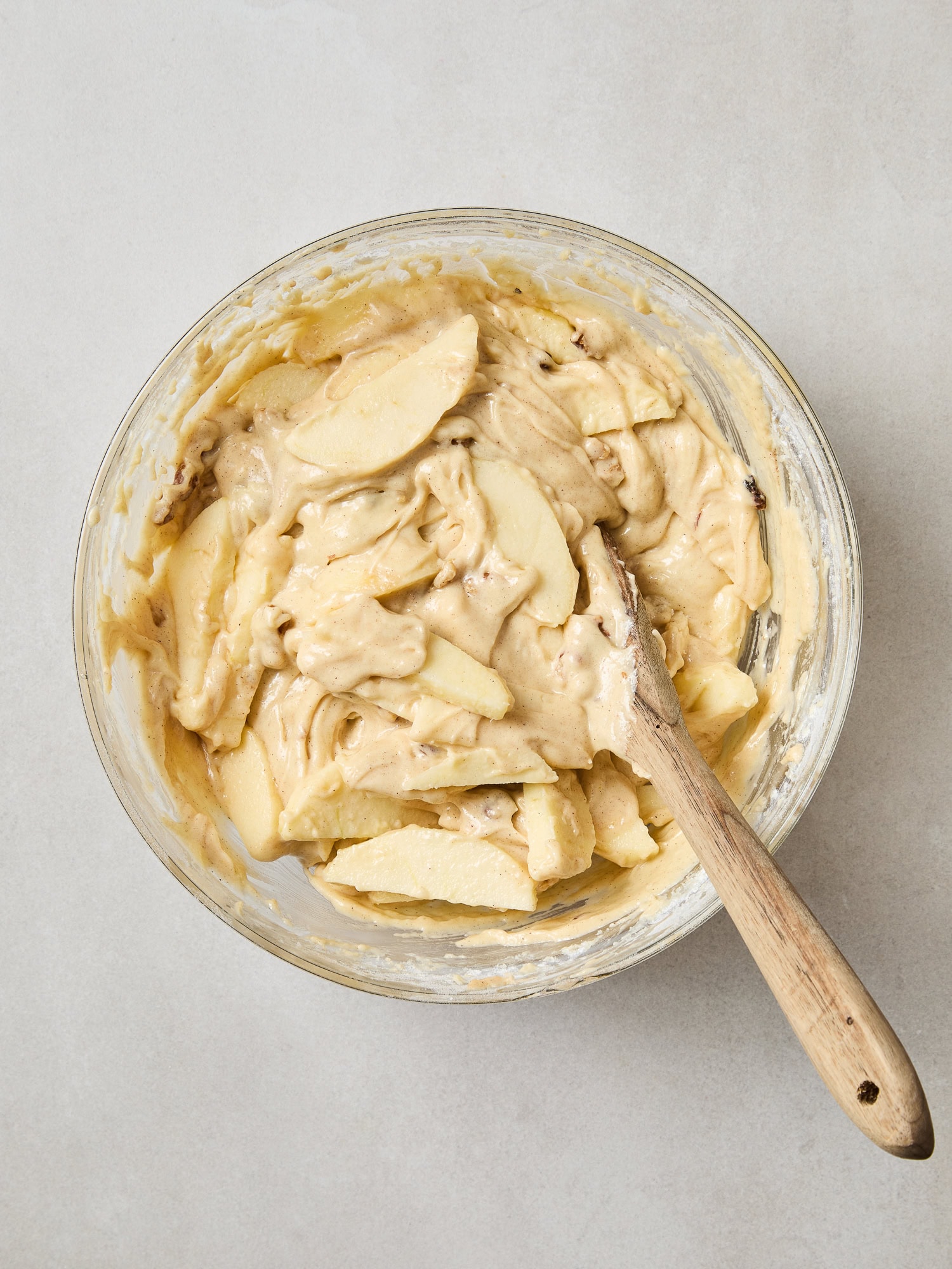 Cake batter after having apple slices folded in.