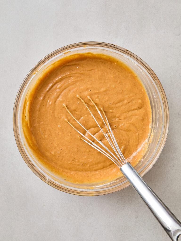 Pumpkin donut batter after being whisked together.