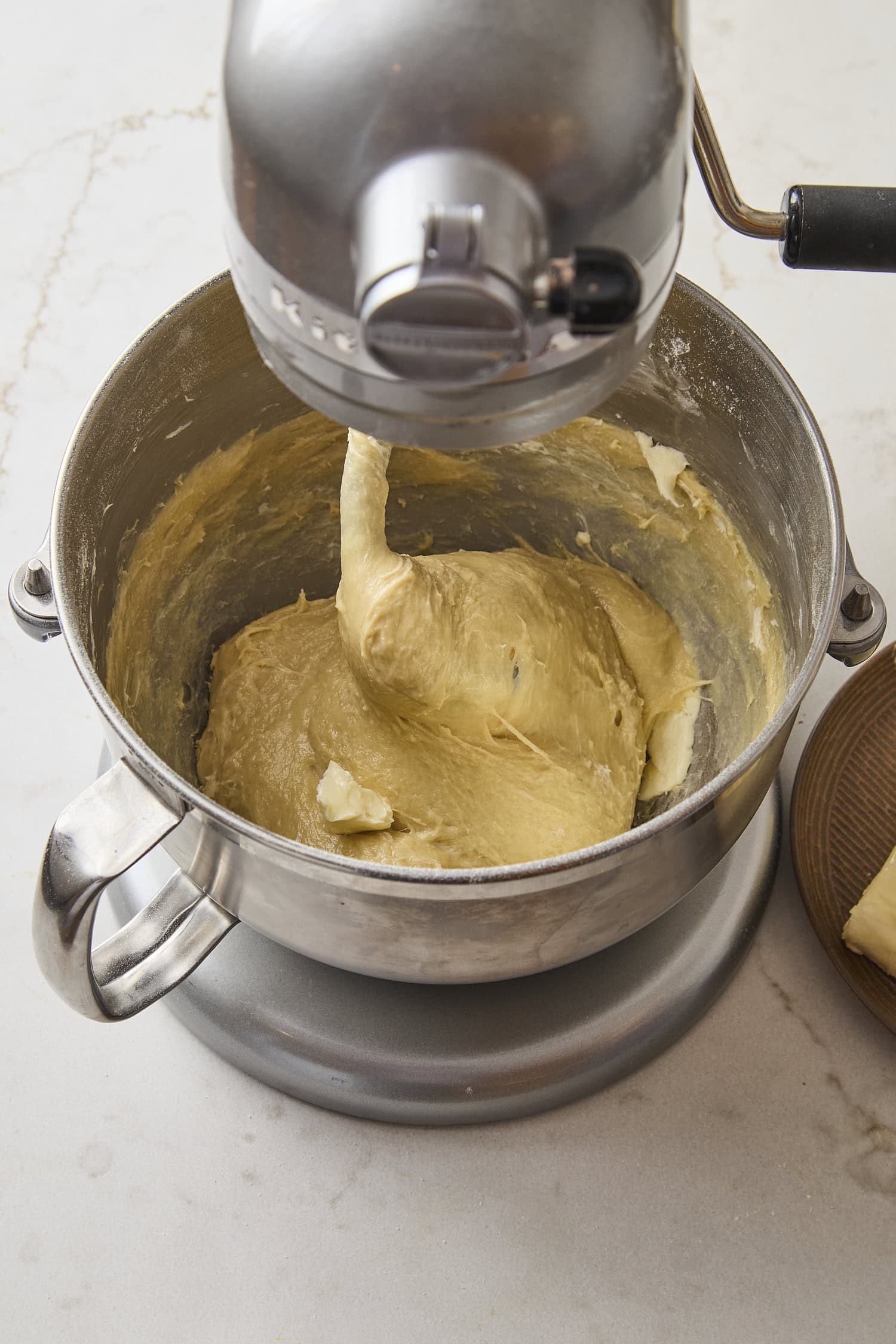 Mixer kneading dough for cinnamon rolls.