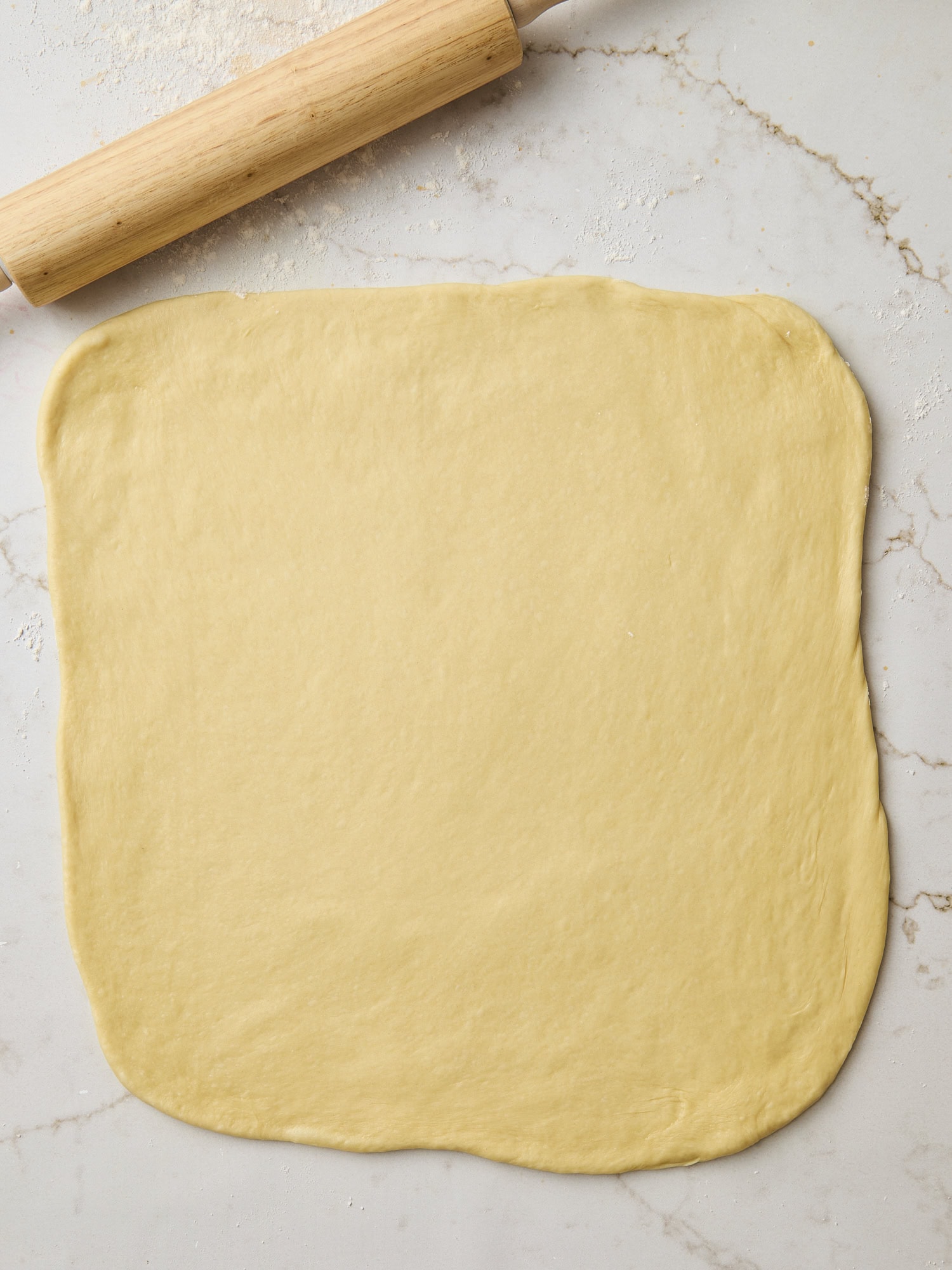 Rolled out brioche dough in a rectangle.