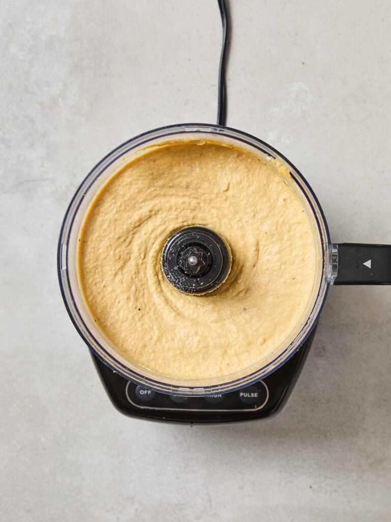 Butternut squash hummus after being creamed in a food processor.