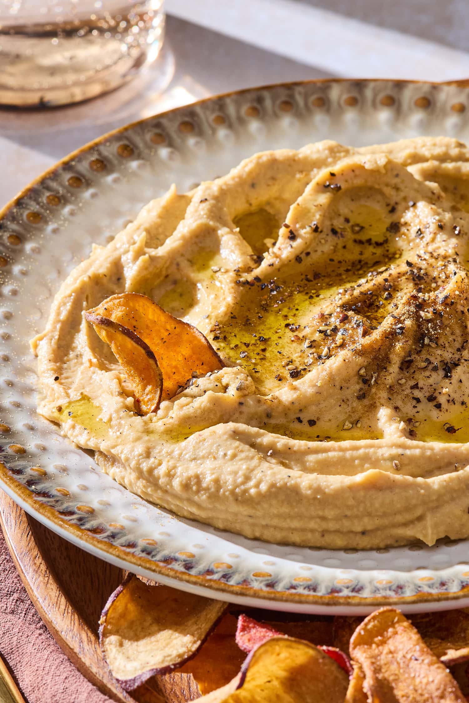 Dipping a chip in butternut squash hummus.