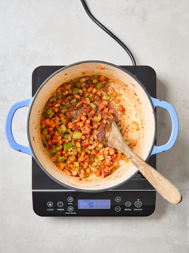 Sautéd vegetables in a Dutch oven.
