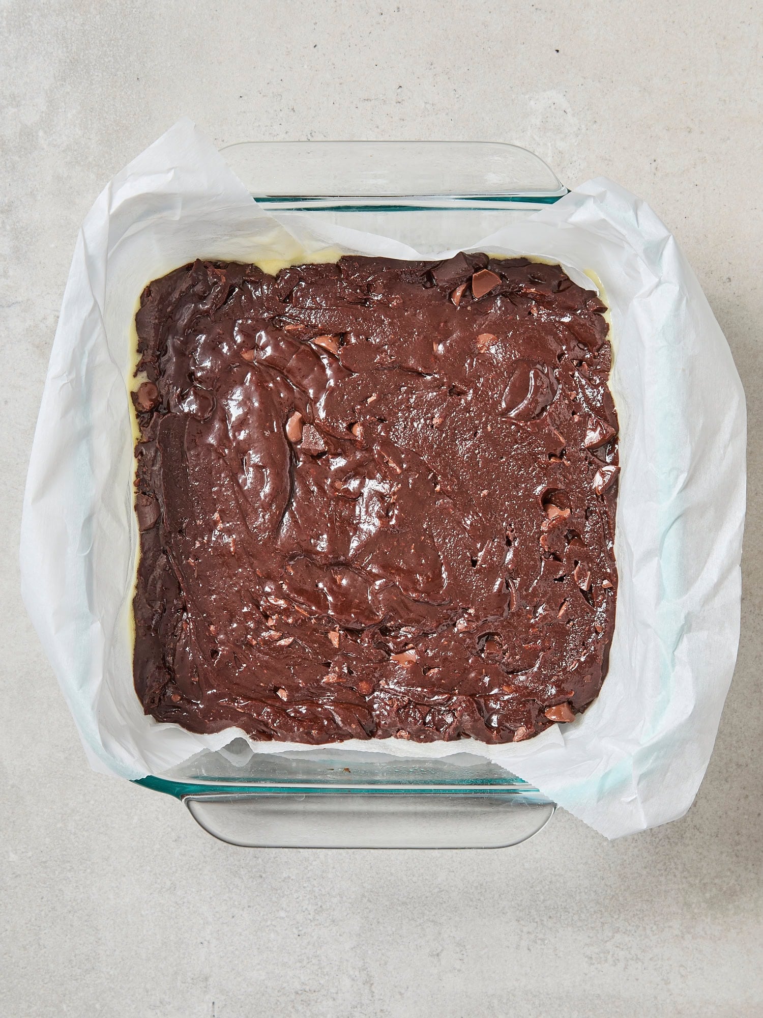Unbaked brownies in a pan right before going into the oven.