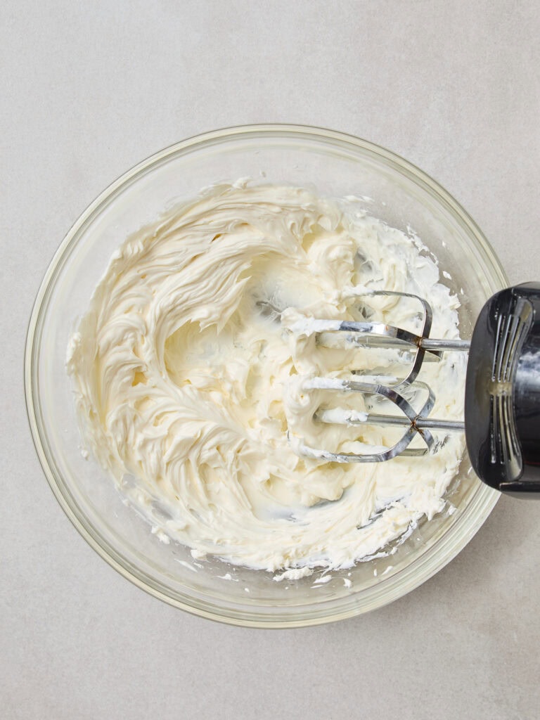 Cream cheese after being whipped by a hand mixer.