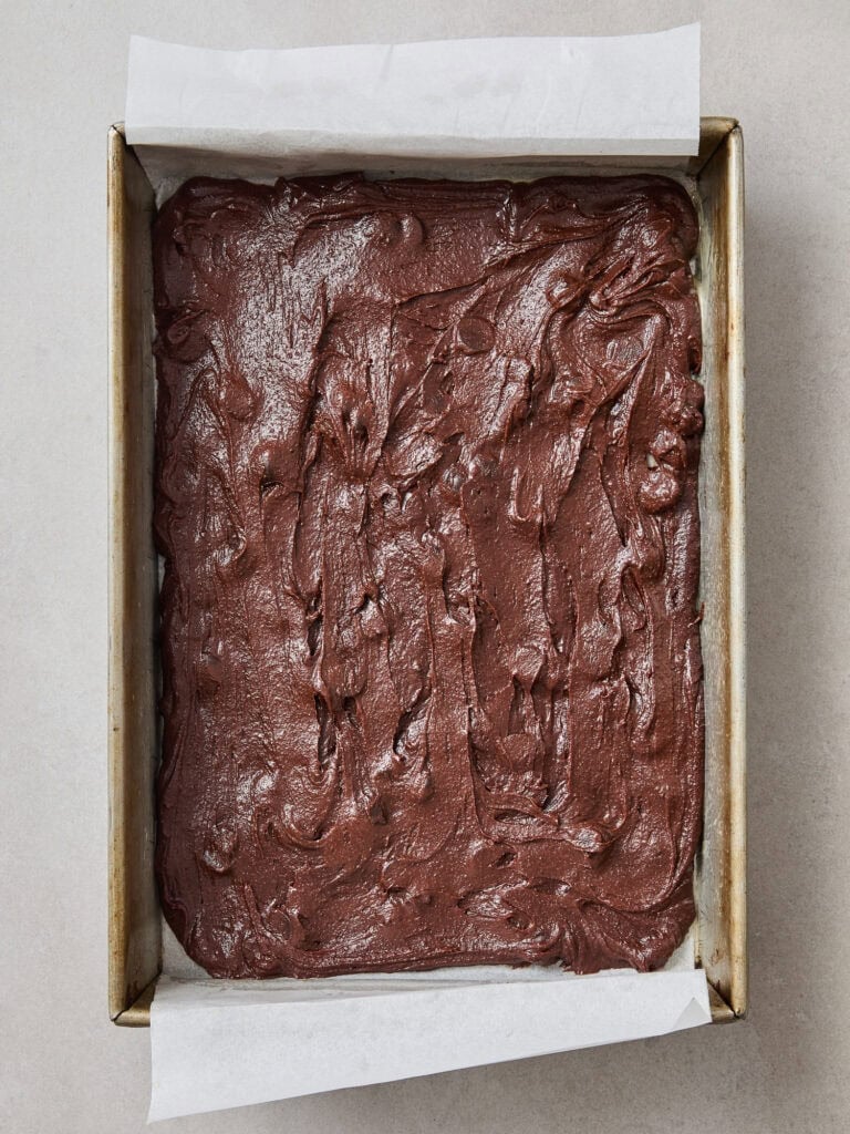 A layer of chocolate brownie in a baking pan.