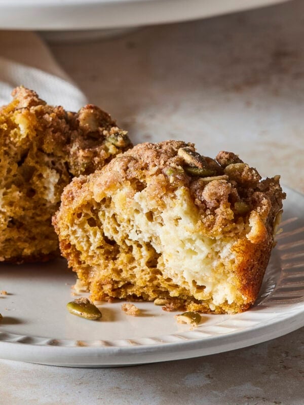 Muffin with cheesecake layer and streusel topping showing.