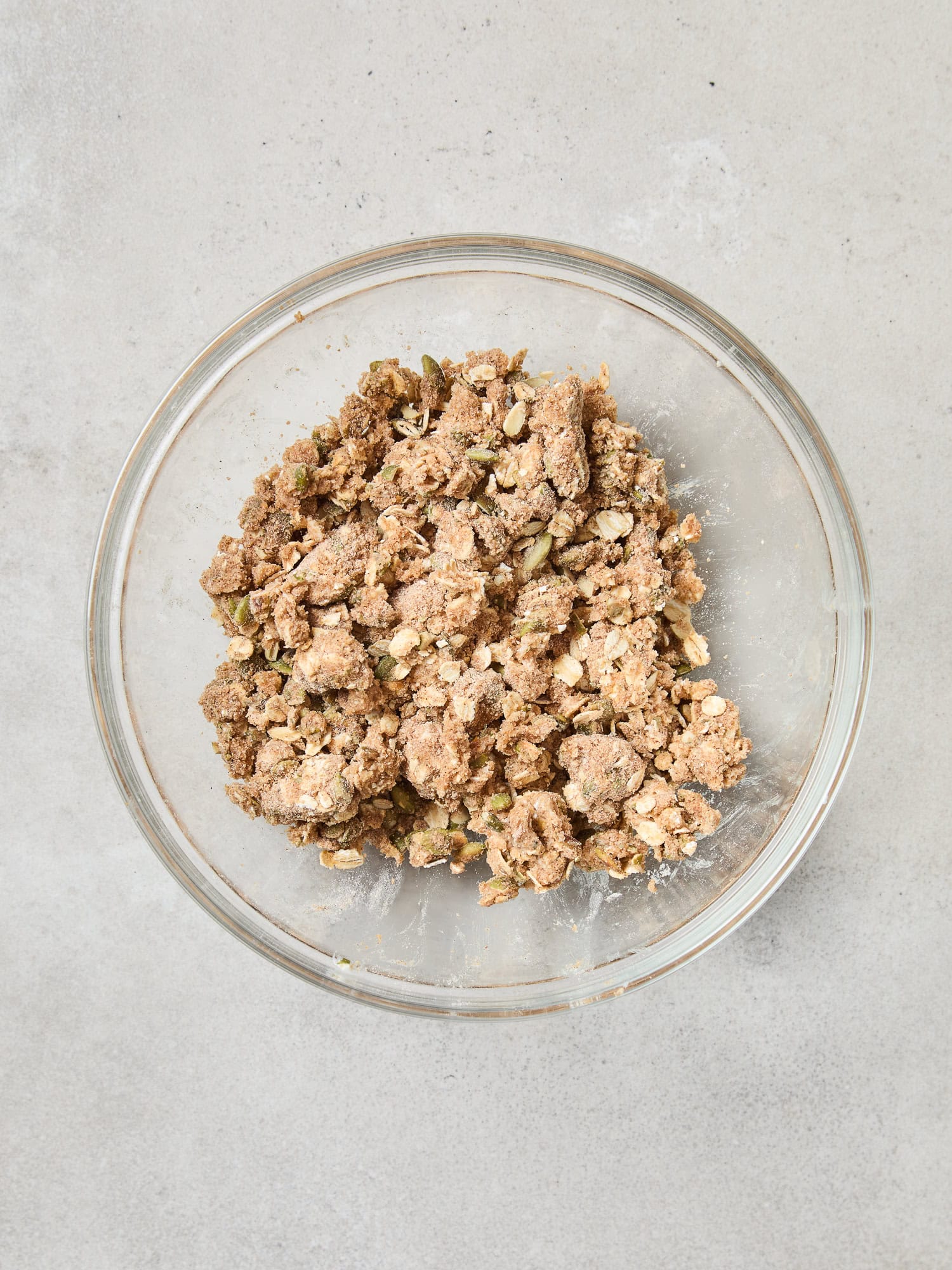 Adding butter to create a streusel topping for muffins.