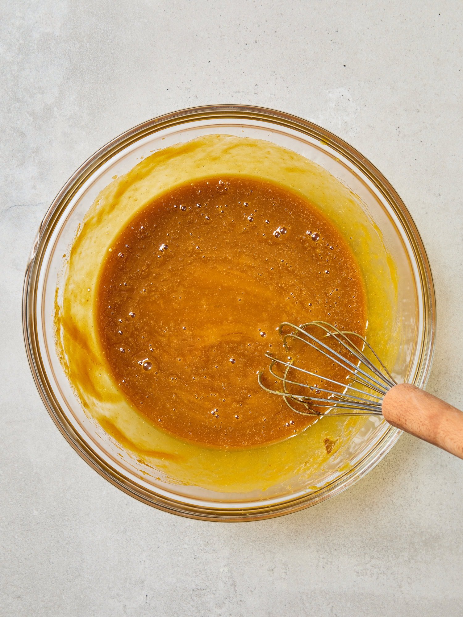 Wet ingredients mixed in a bowl for pumpkin muffins.