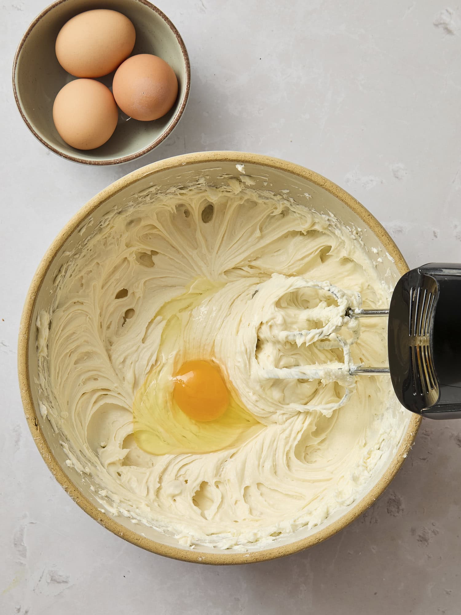 Mixing bowl with eggs before being mixed.