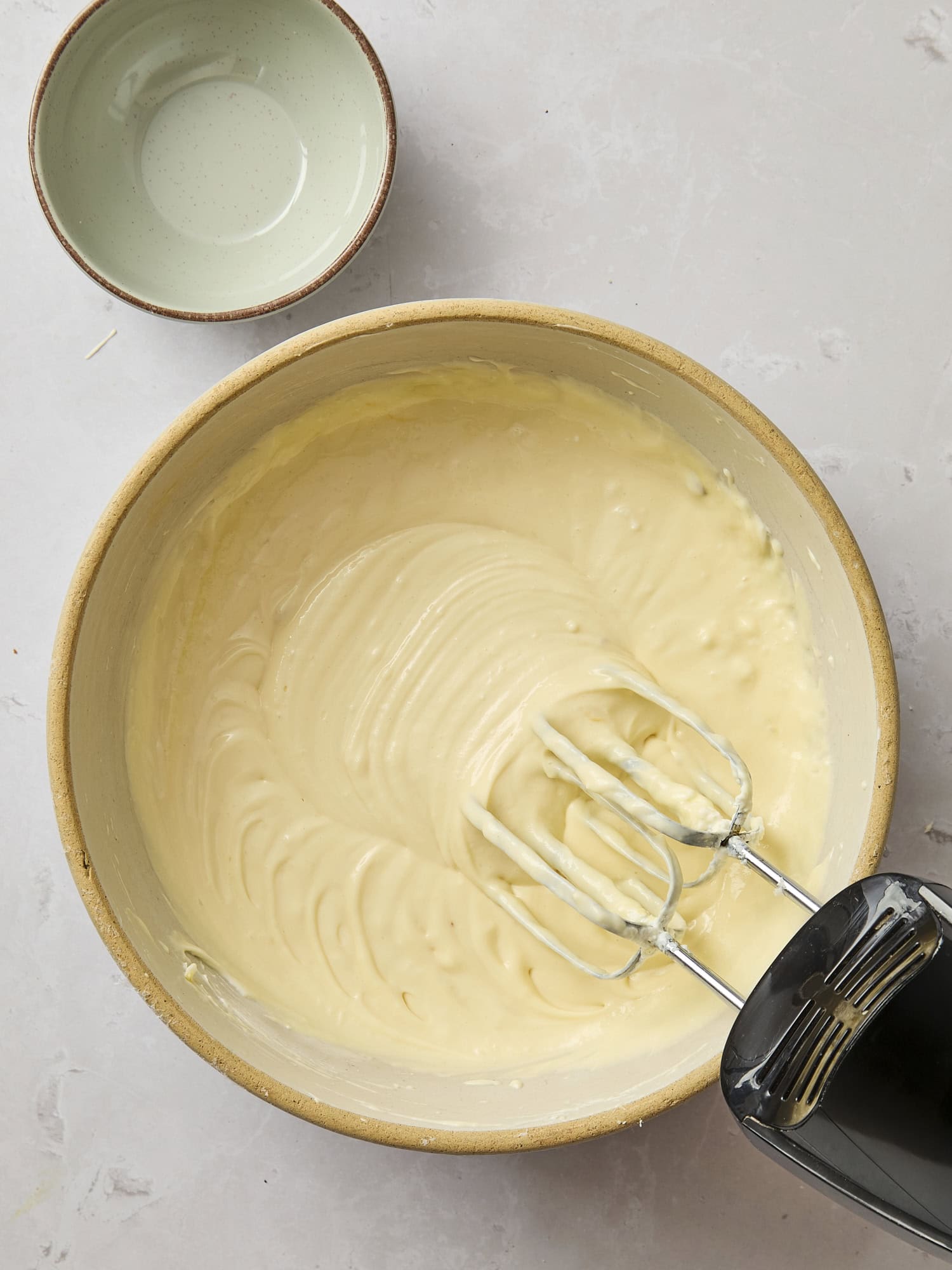 Mixing bowl with batter for pumpkin cheesecake.