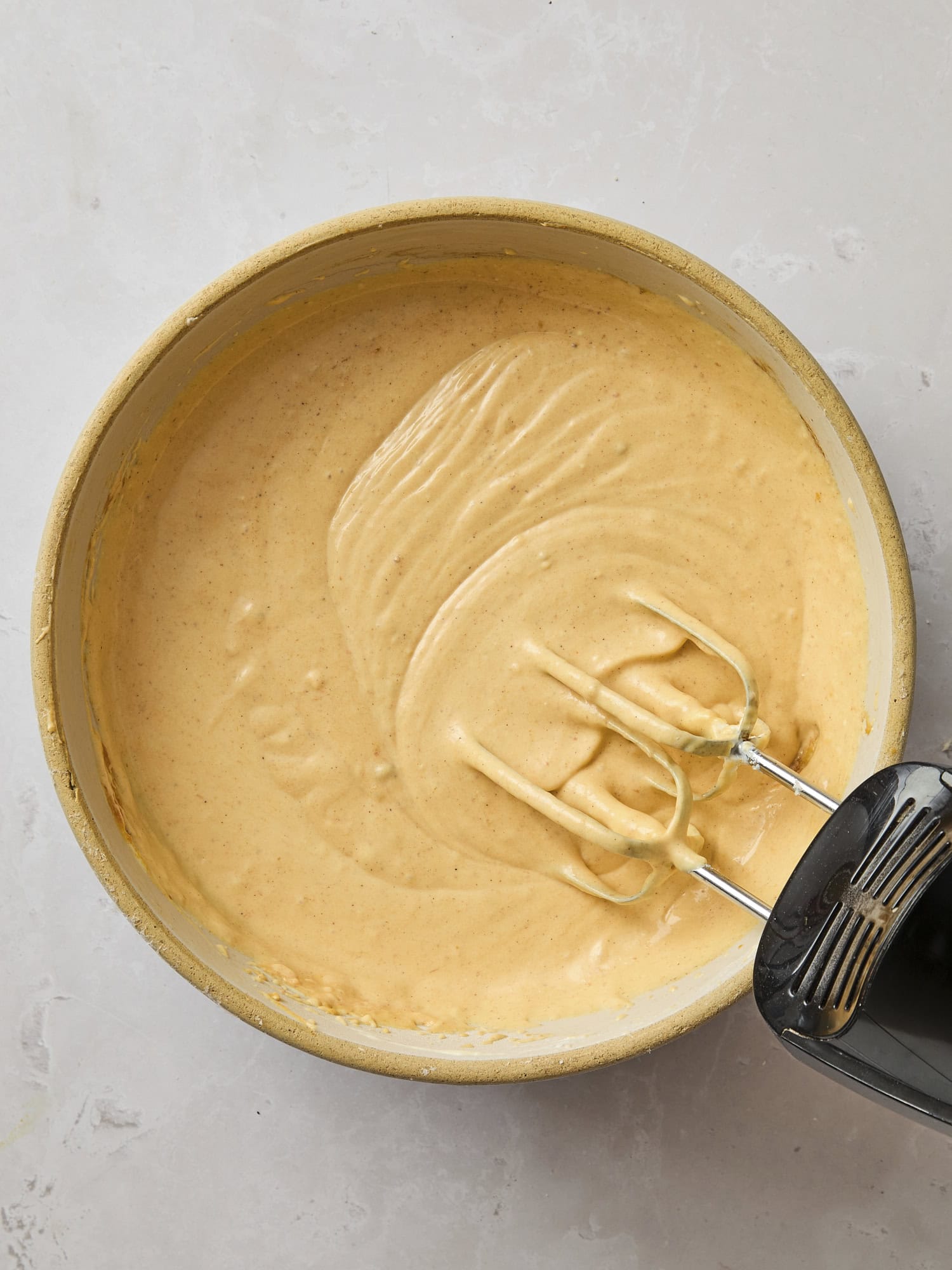 Mixing bowl with mixed batter for Basque pumpkin cheesecake.