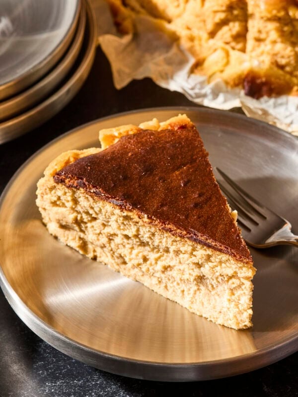 Slice of Basque pumpkin cheesecake on a metal plate with fork.