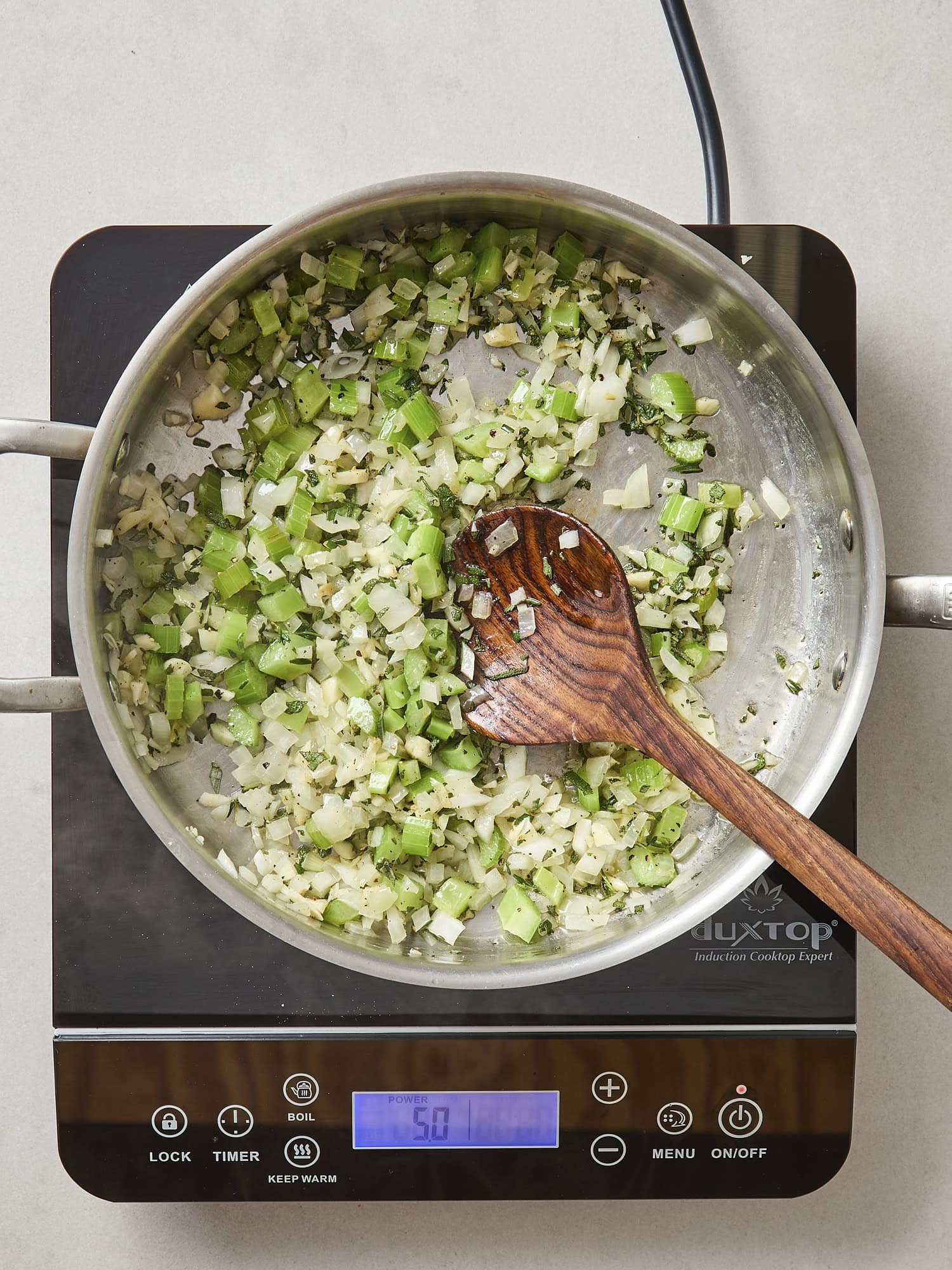 Aromatics of celery and onion cooking in a pot.