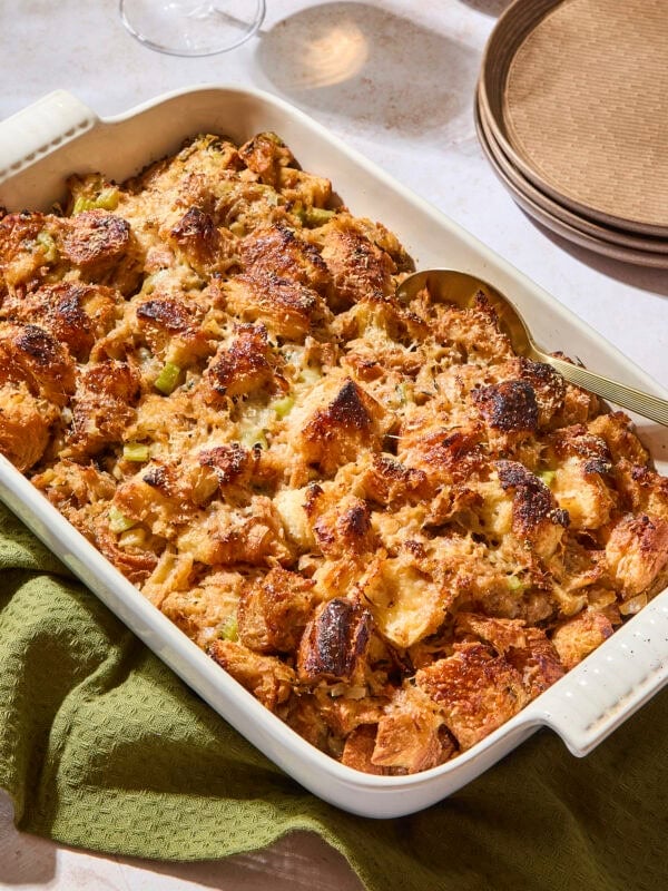 White baking pan filled with croissant stuffing with crispy top.