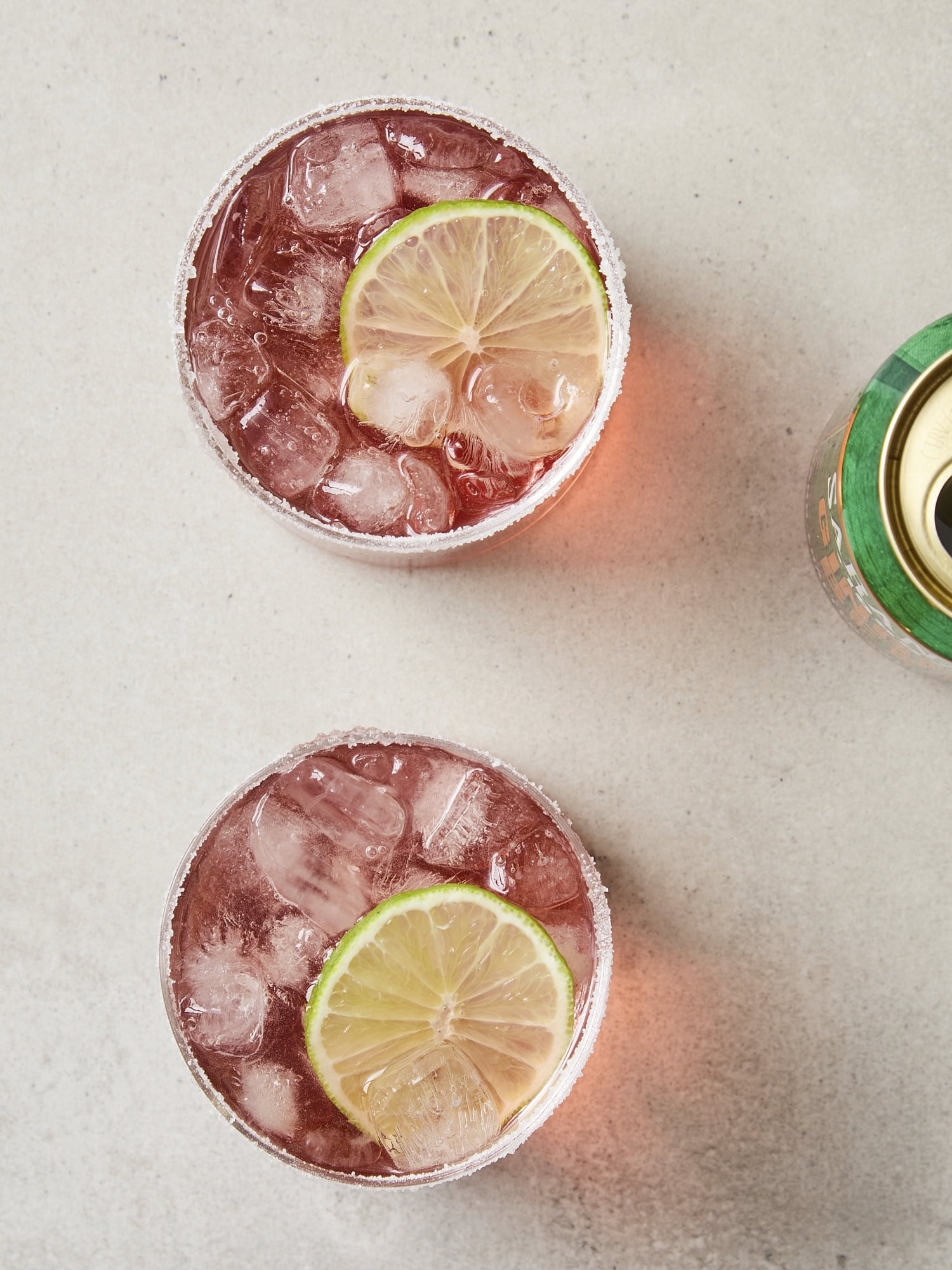 Two glasses made with margarita with lime wedge and topped with ginger beer.