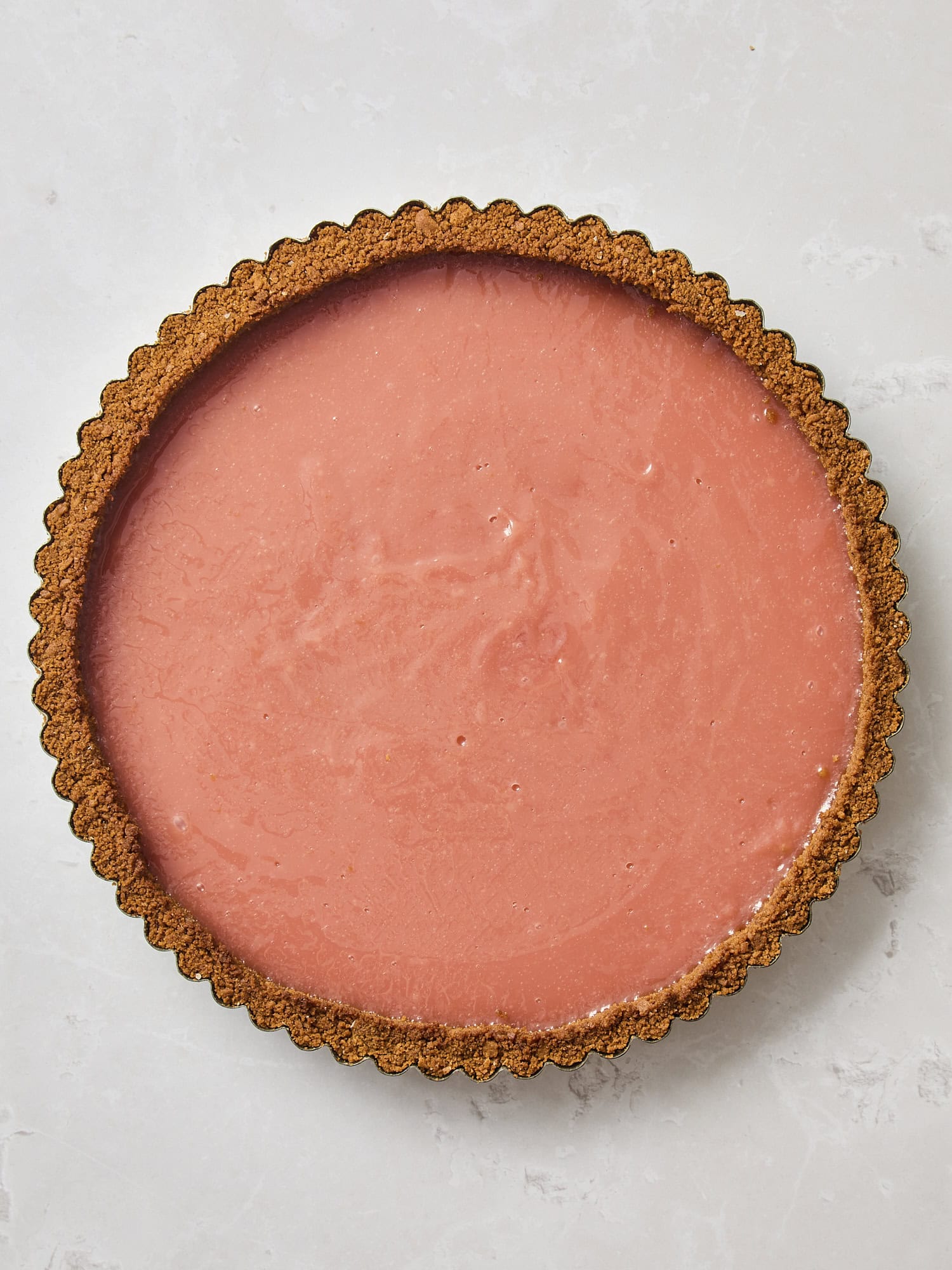 Tart pan filled with cranberry filling.