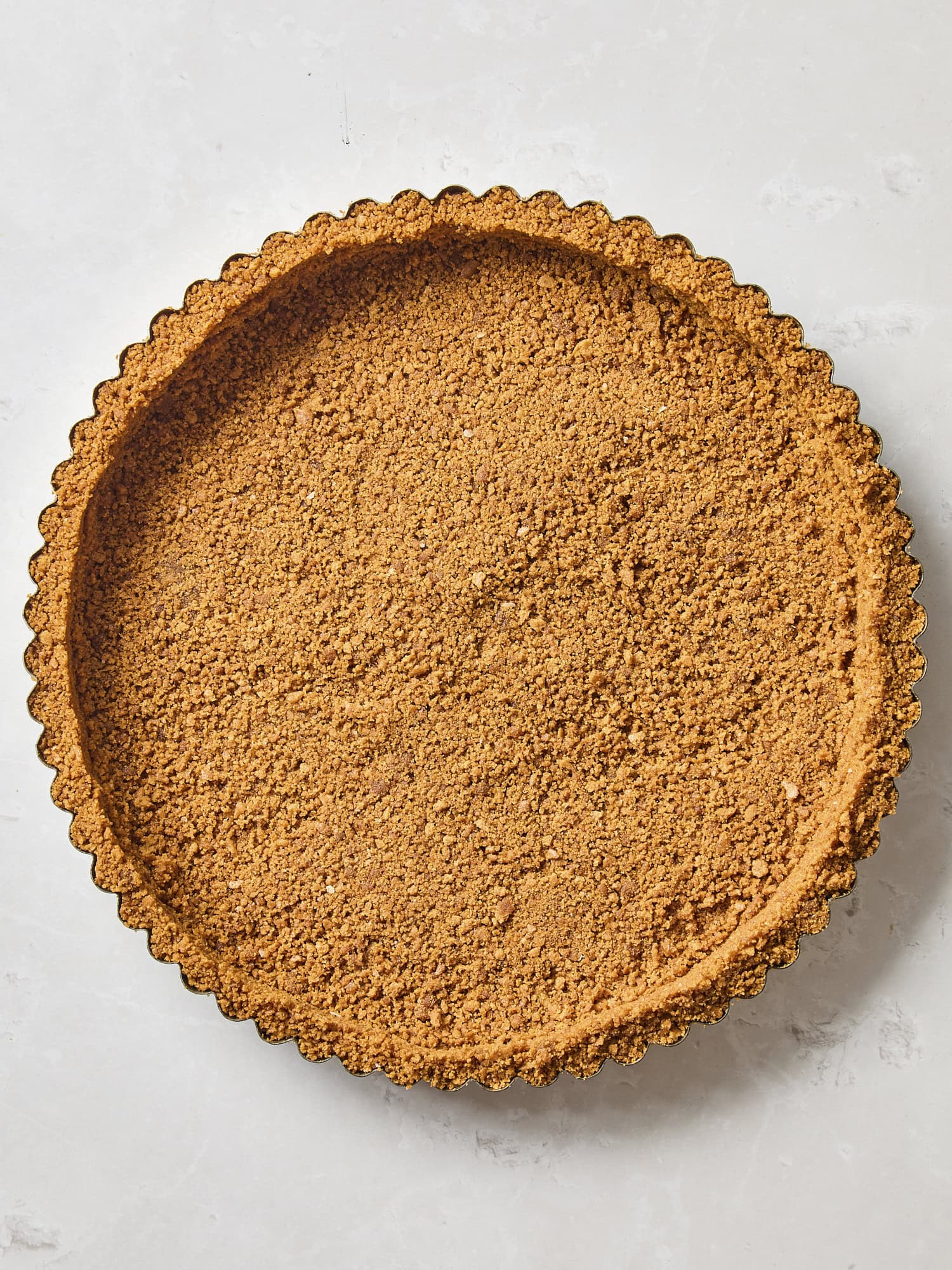Gingersnap cookie crust pressed into a tart pan.