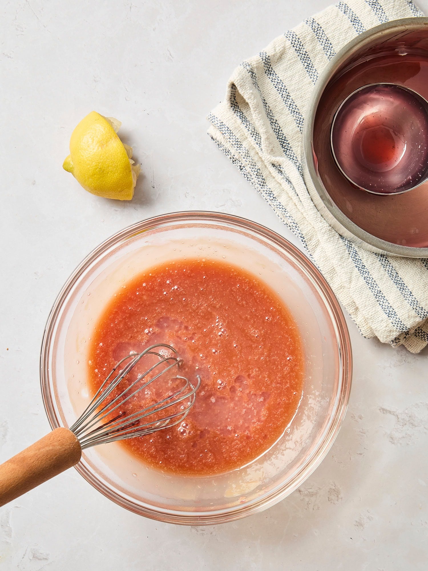 Glass bowl with cranberry tart filling with lemon juice added in.