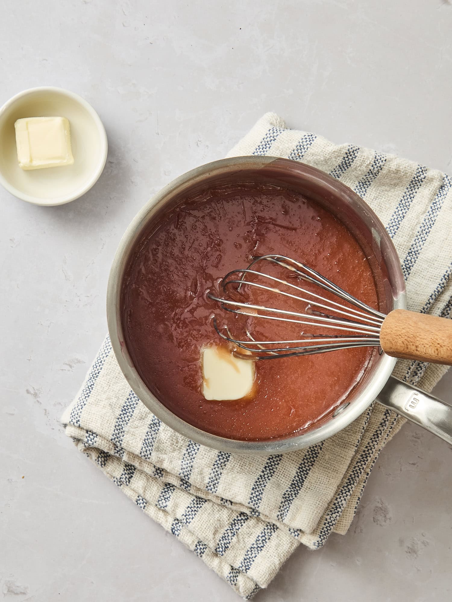 Saucepan with butter being mixed into cranberry filling.
