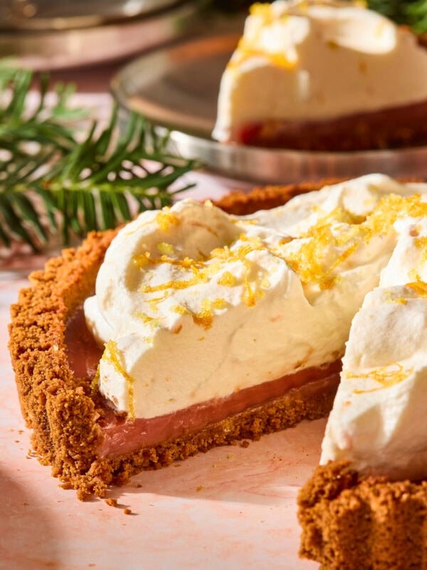 Cranberry tart with a slice missing showing the interior texture.