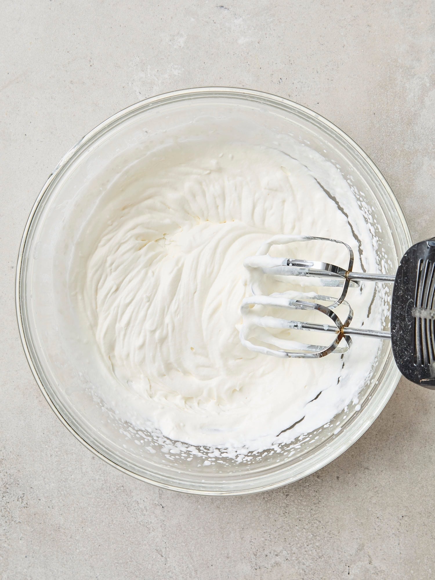 Glass bowl with whipped cream mixture.