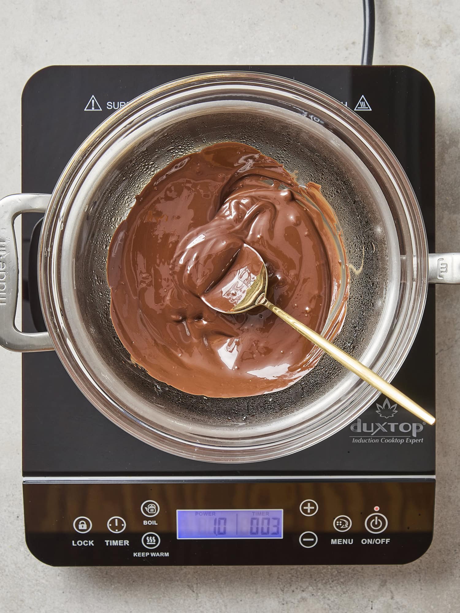 Chocolate melting in a glass bowl.