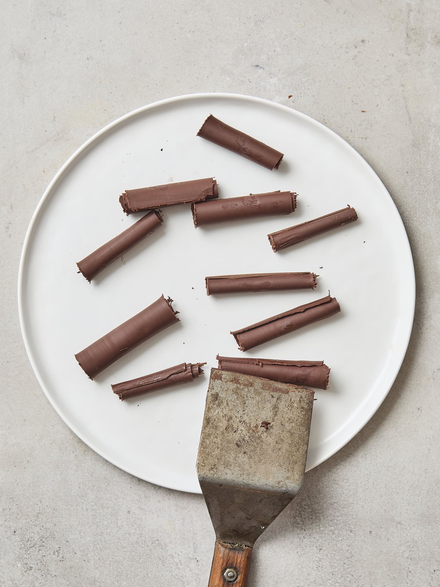 Plate with chocolate curls after coming off baking sheet.