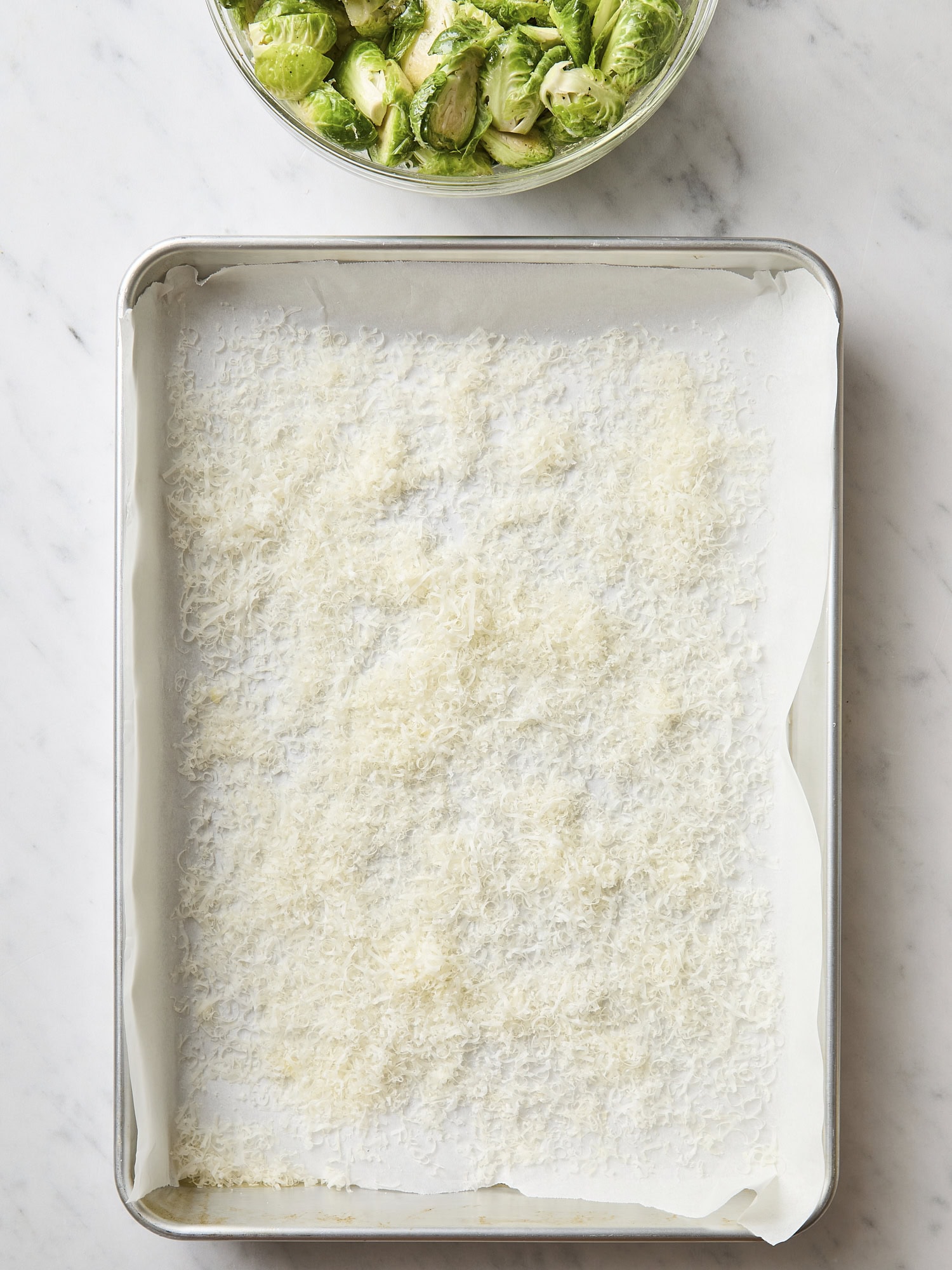 Sheet pan with Parmesan cheese all over.
