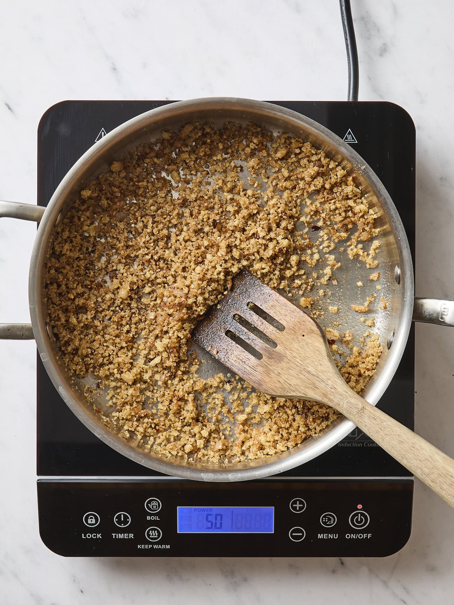 Pan filled with breadcrumbs after being cooked with butter.