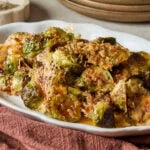 White platter with roasted Brussels sprouts side dish for Thanksgiving.