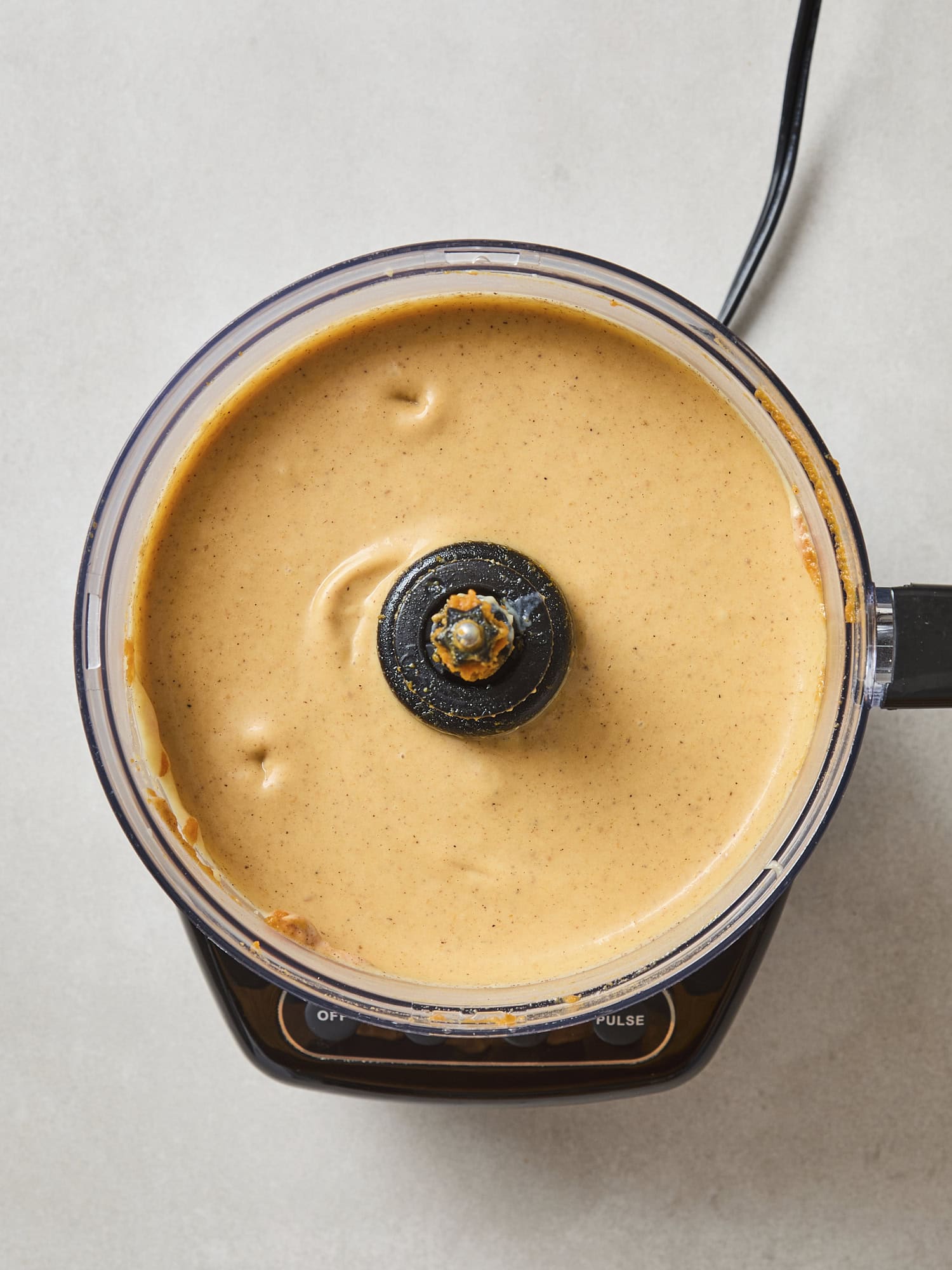 Food processor filled with pumpkin filling.