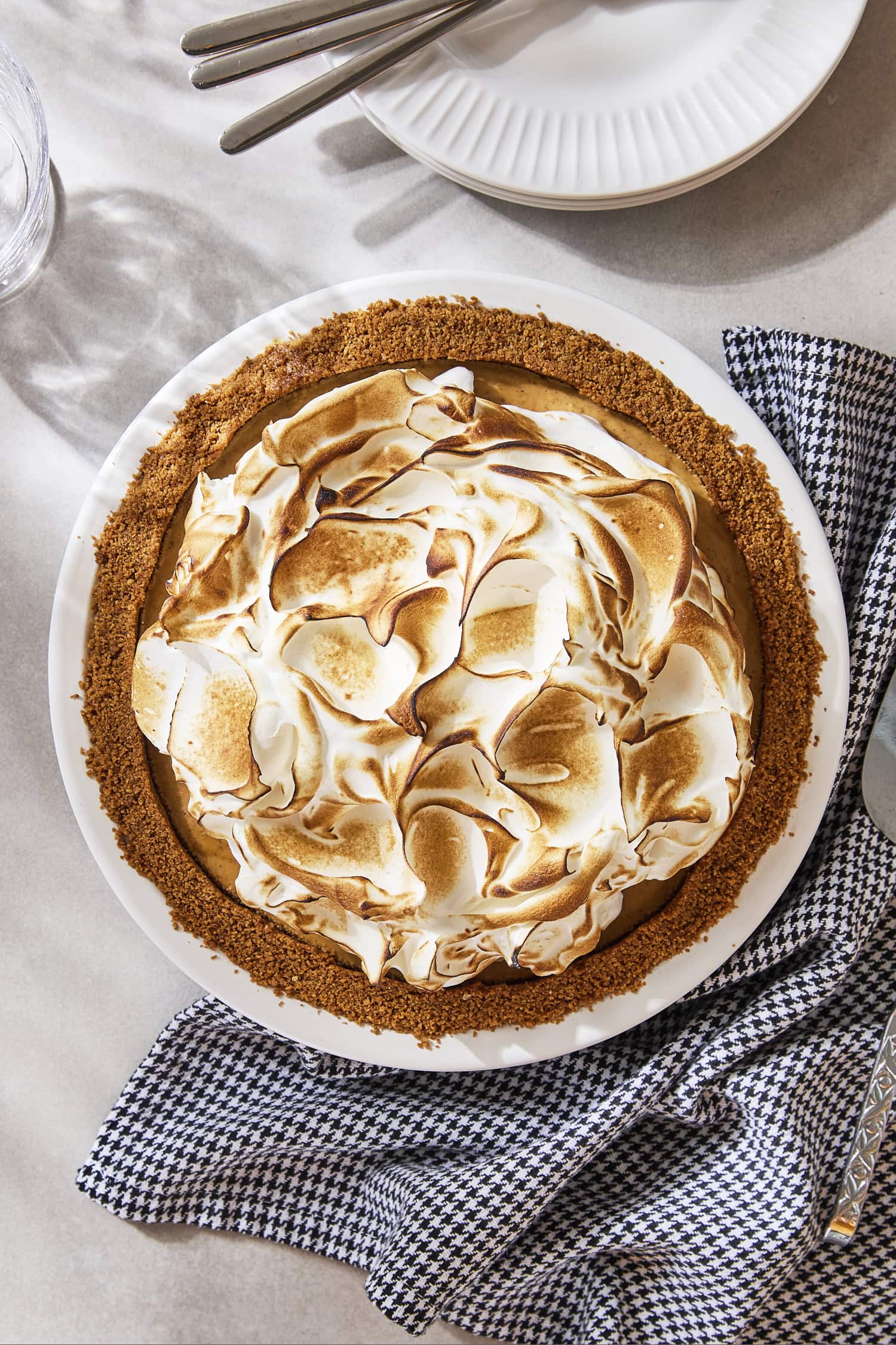 Pumpkin pudding pie with brûlée on top before being sliced.