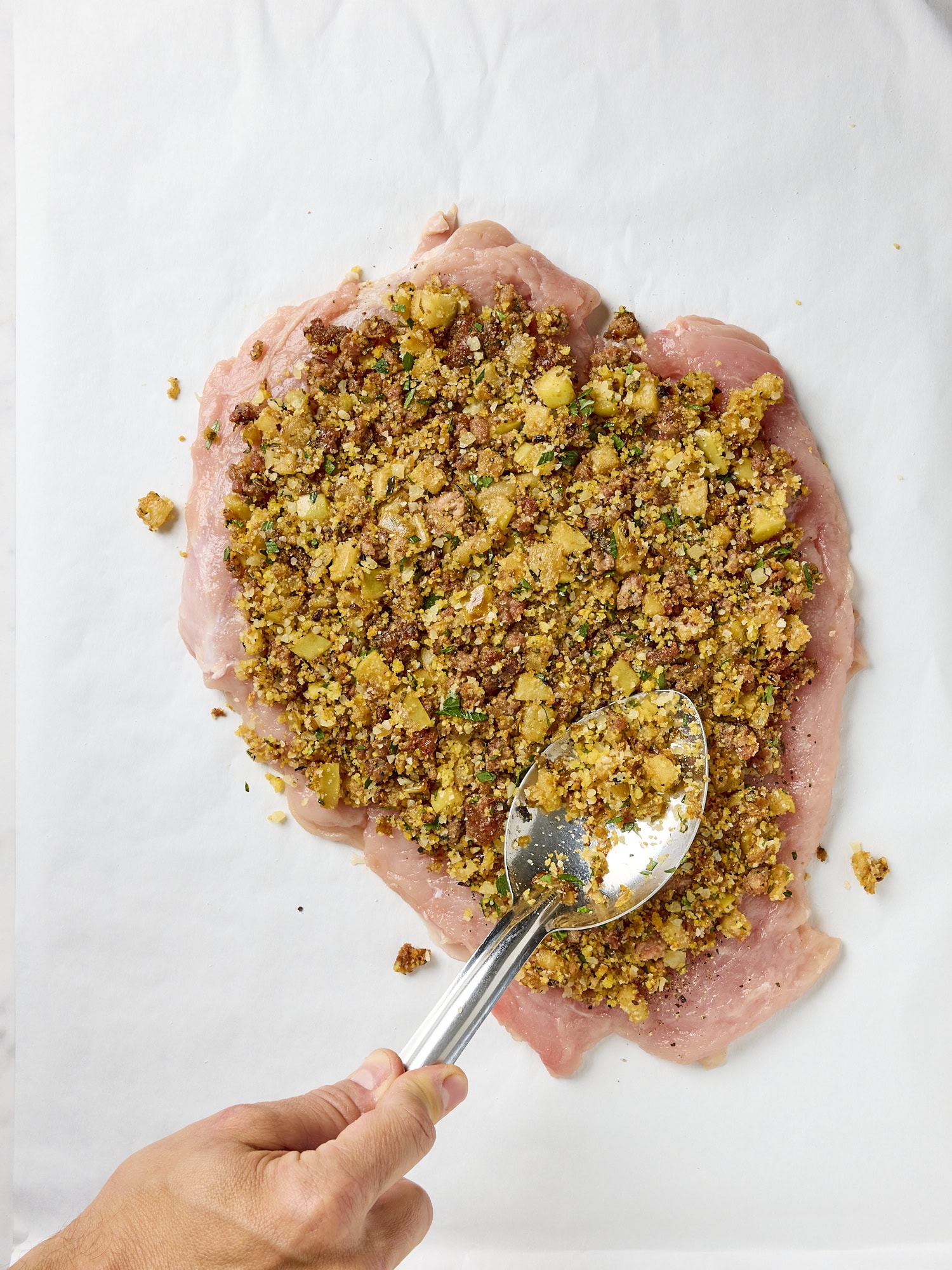 Filling on top of a turkey breast pounded out flat.