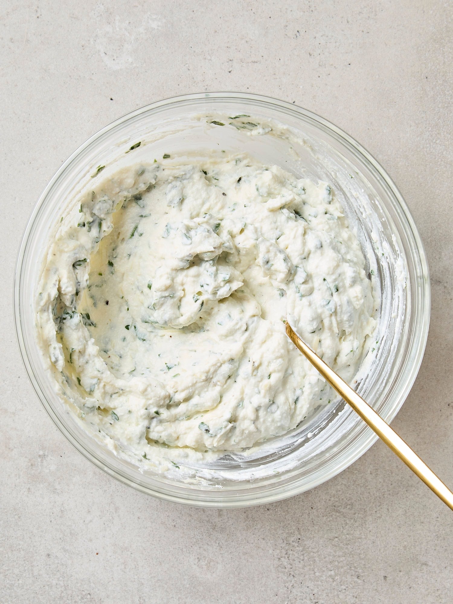 Bowl of ricotta mixture for a baked ziti.
