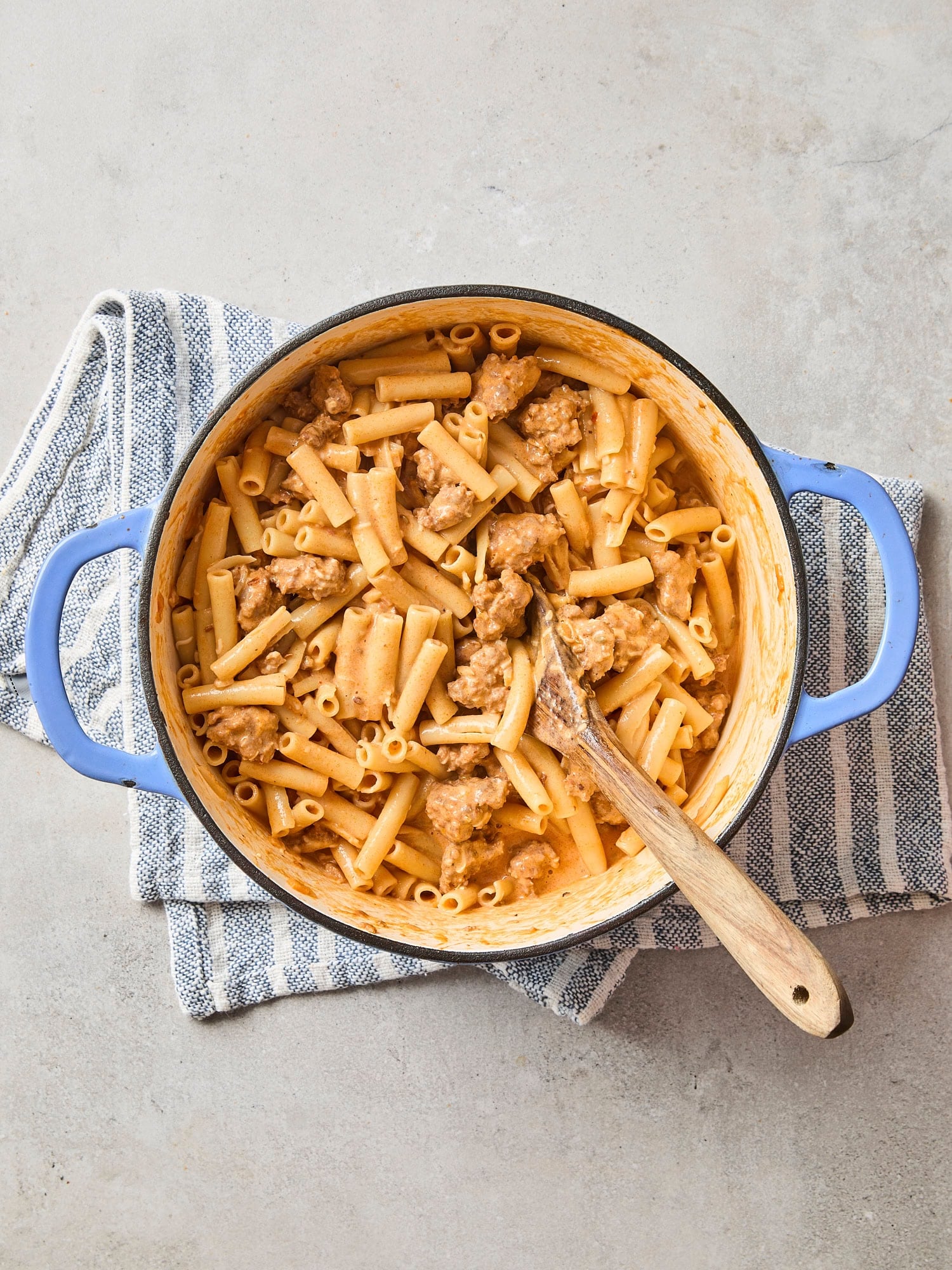 Pot of pasta with sausage and creamy sauce for baked ziti.