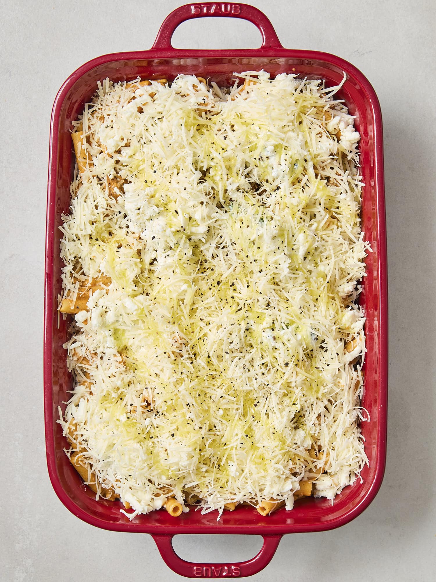 Parmesan cheese with drizzle of olive oil for baked ziti.