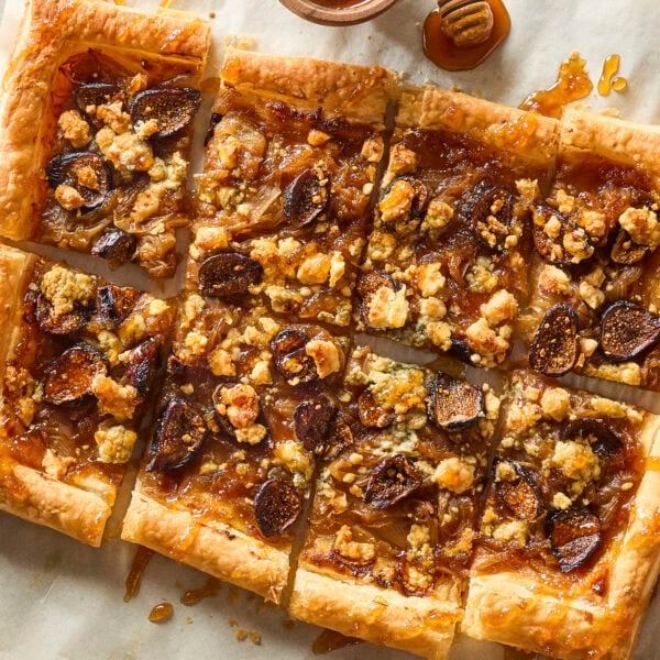 Baked caramelized onion tart drizzled with honey and topped with figs and blue cheese.
