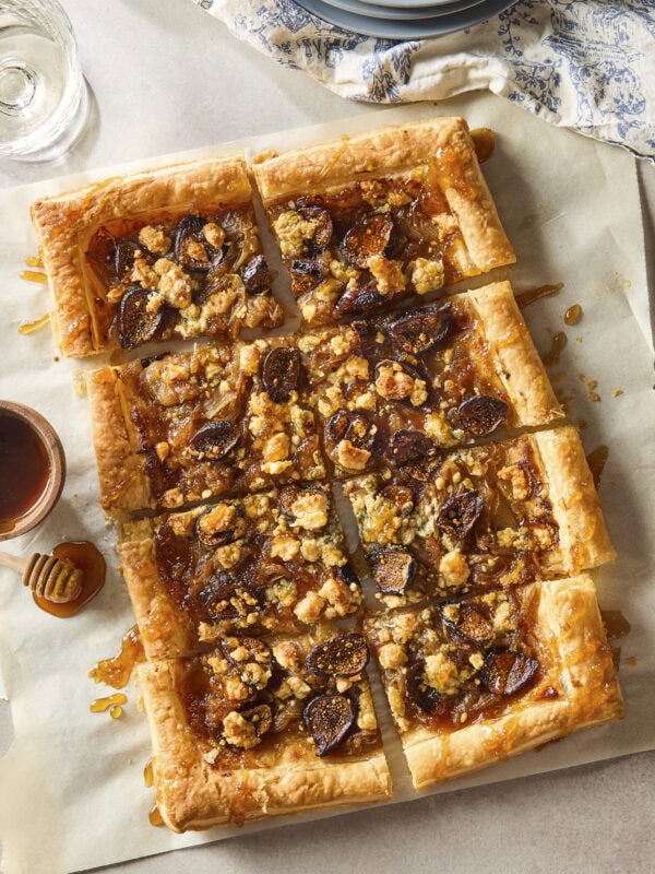Caramelized onion tart with golden crispy crust drizzled with honey.