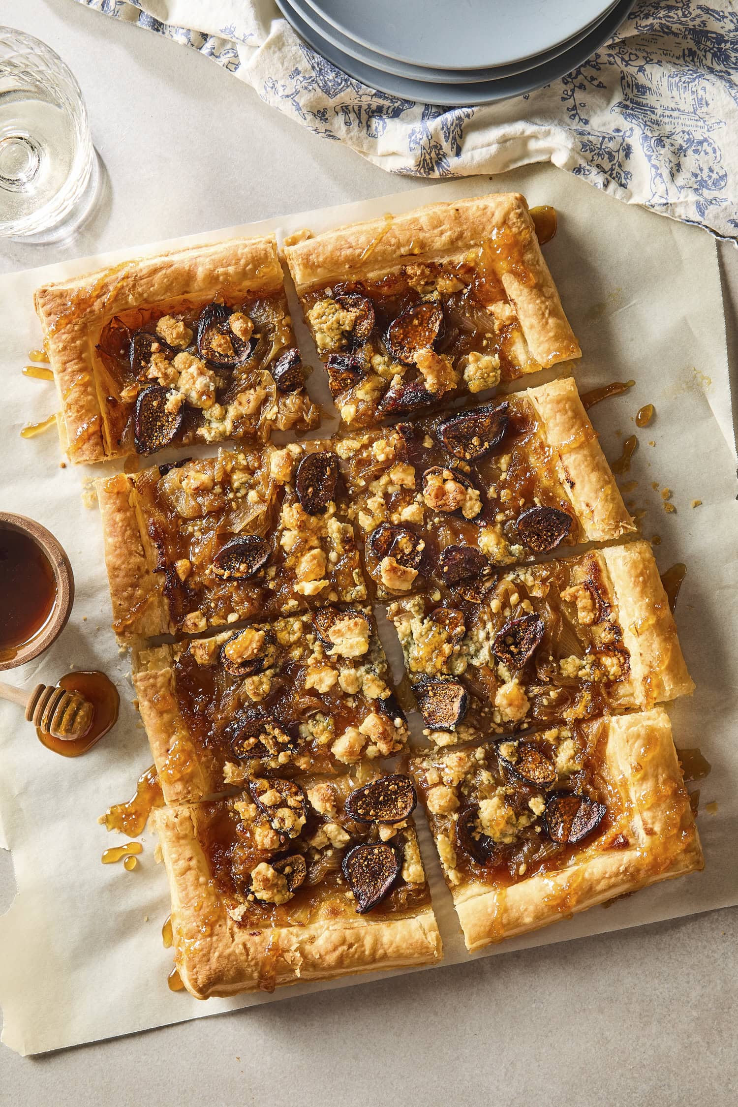 Caramelized onion tart with golden crispy crust drizzled with honey.