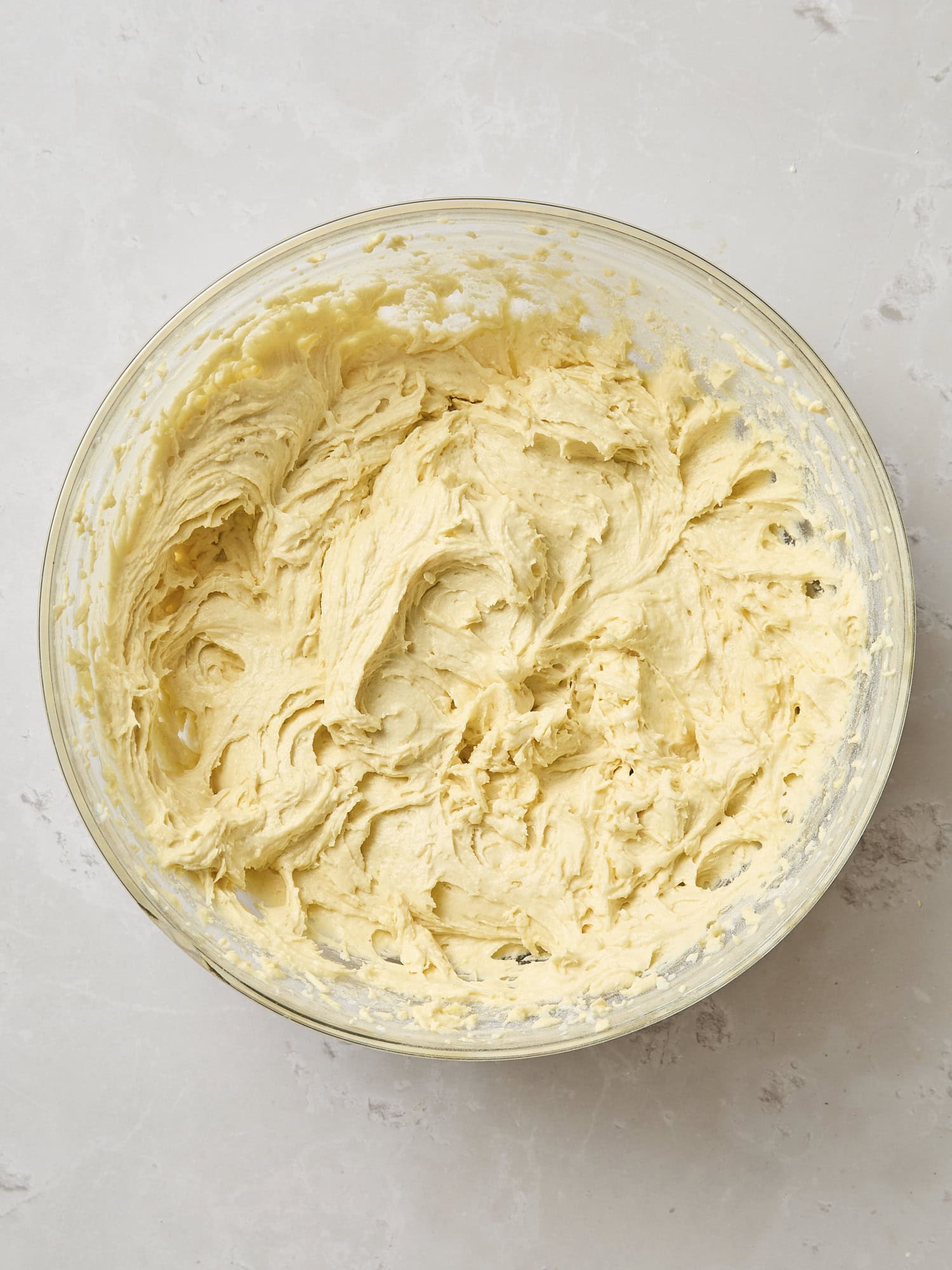 Glass bowl with mixed batter for a frangipane coffee cake.