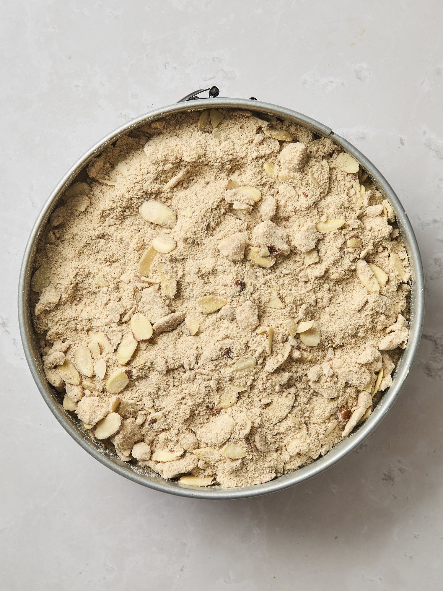 Streusel topping in a springform pan as part of a coffee cake.