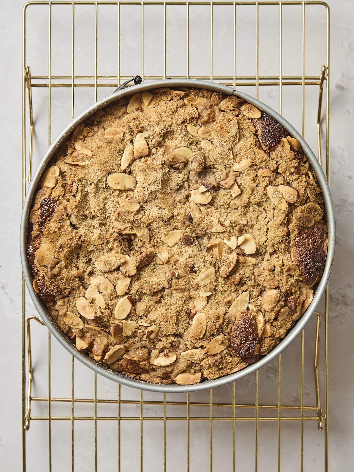 Baked frangipane coffee cake cooling on a rack.
