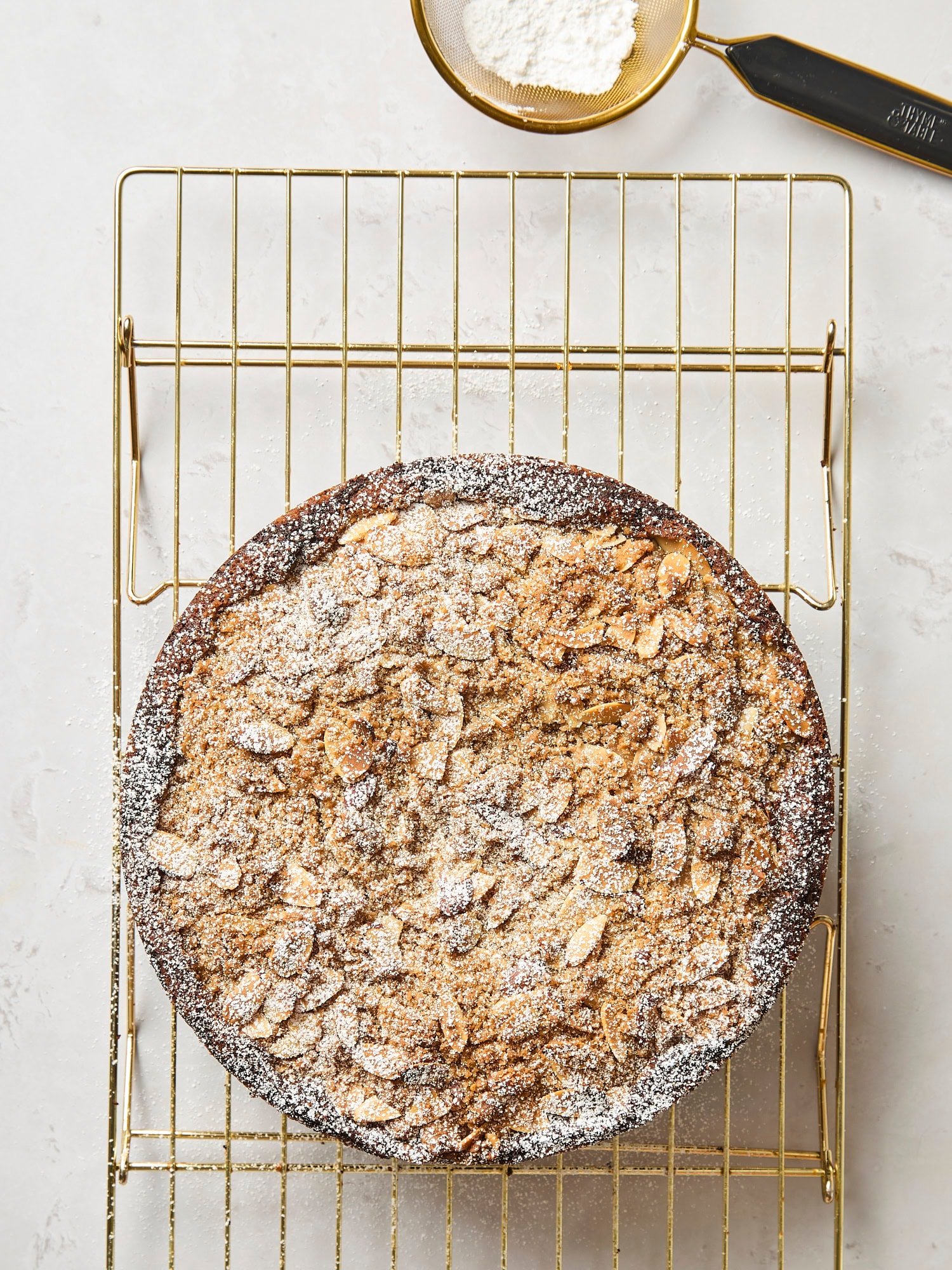 Frangipane coffee cake with dusting of powdered sugar on top.