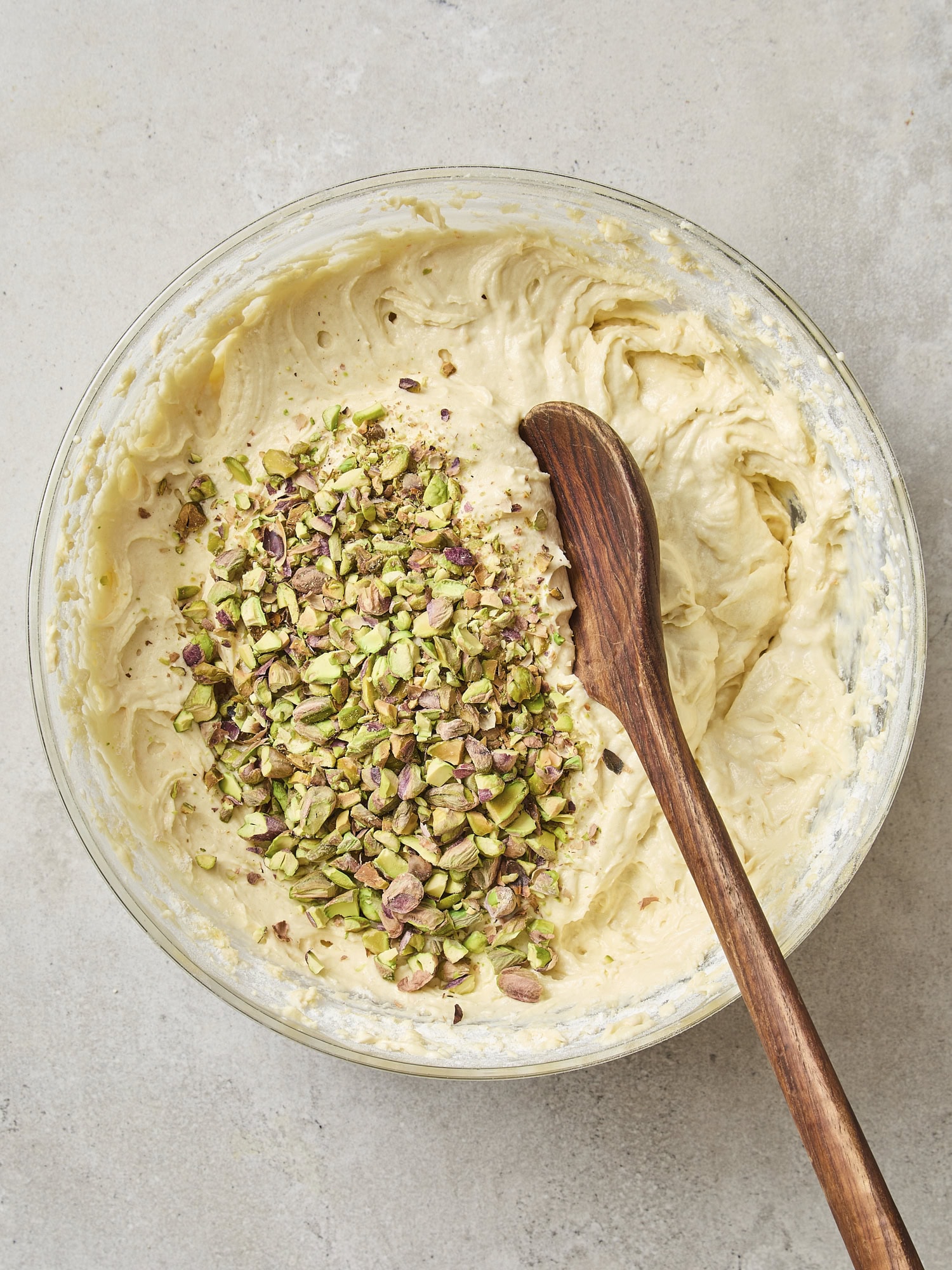 Whole with pistachios and wooden spoon and batter before mixing together.