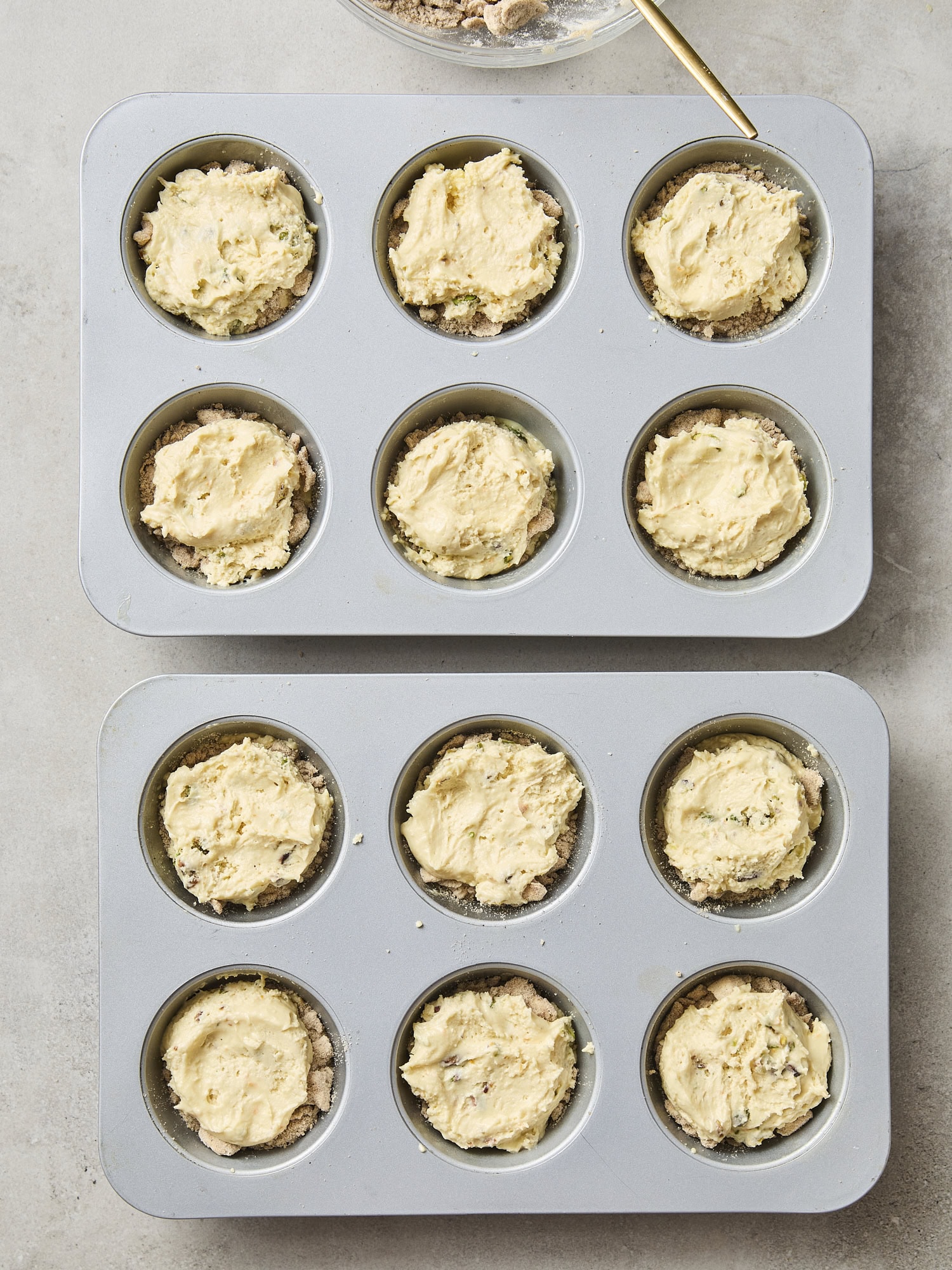 Batter portioned into muffin tins.